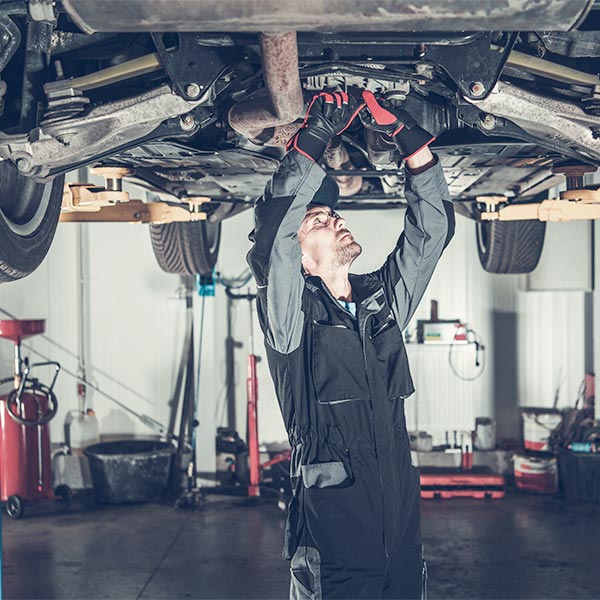 Mechanic Fixing Car on a Lift